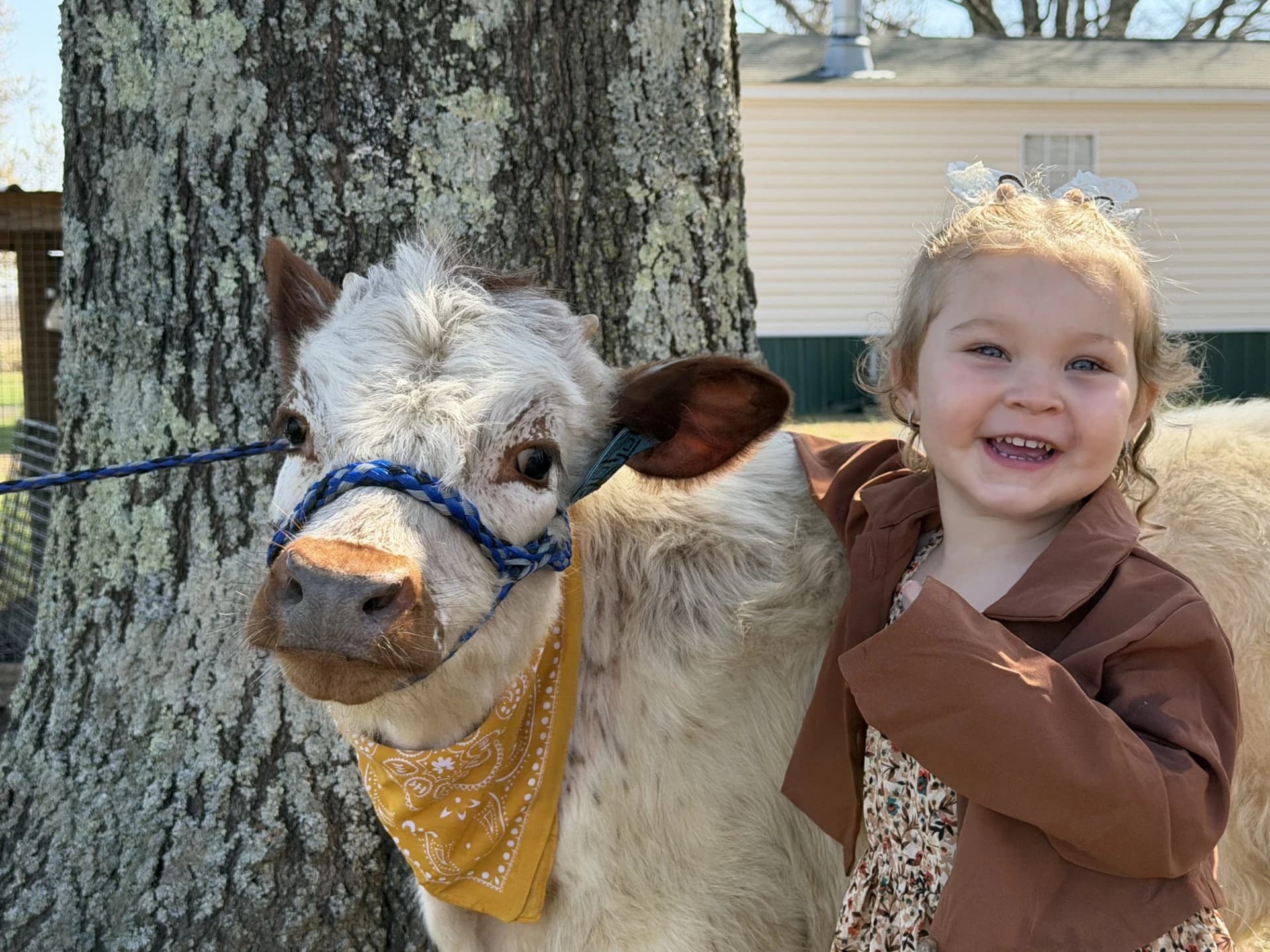 Kinleigh smiling beside a calf